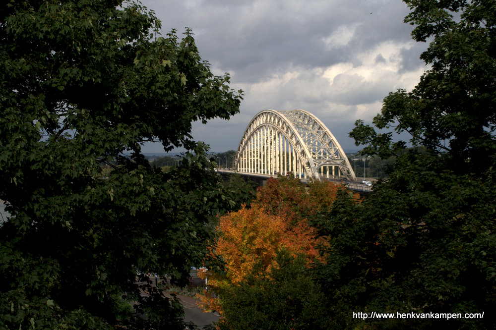 View of the bridge over the river Waal in Nijmegen, with autumn colors in the foreground